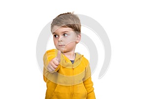 Portrait of beautiful little boy giving you thumbs up over white background