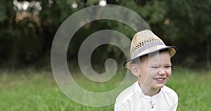 Portrait of a beautiful little boy laughing and having fun in the park