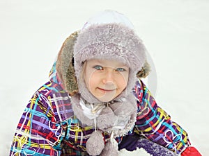 Portrait of a beautiful little cheerful girl. A child in the winter outdoors