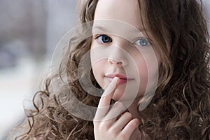 Portrait of beautiful little girl applying lipbalm