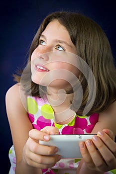 Portrait of beautiful little girl with cell phone