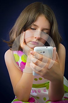 Portrait of beautiful little girl with cell phone
