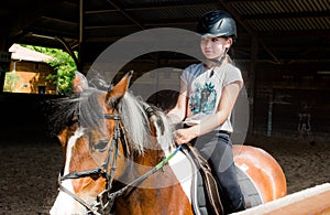 Portrait of a beautiful little girl on her pony