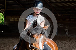 Portrait of a beautiful little girl on her pony