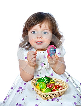 portrait of a beautiful little girl holding Easter eggs on a white background