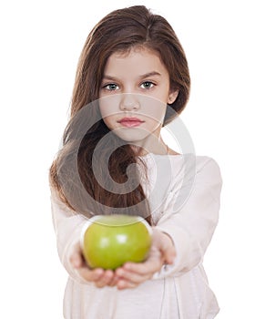 Portrait of a beautiful little girl holding a green apple