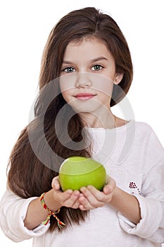 Portrait of a beautiful little girl holding a green apple