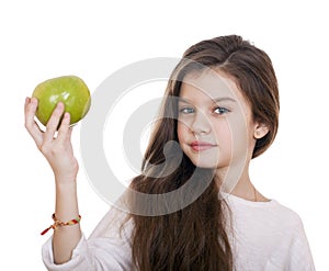 Portrait of a beautiful little girl holding a green apple