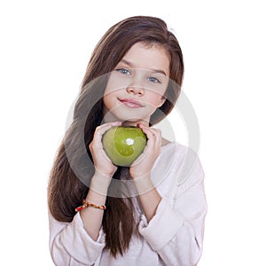 Portrait of a beautiful little girl holding a green apple