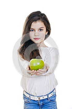 Portrait of a beautiful little girl holding a green apple