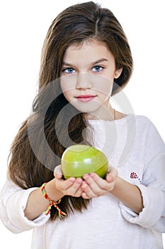 Portrait of a beautiful little girl holding a green apple