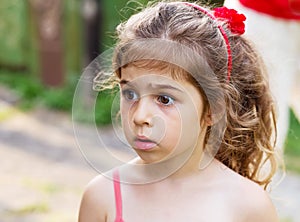 Portrait of beautiful little girl looking sad and afraid o