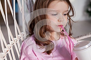 Portrait of a beautiful little girl in a pink dress five years