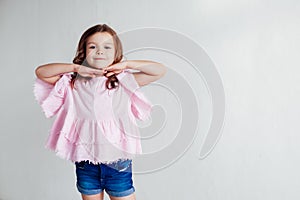 Portrait of a beautiful little girl in a pink dress five years