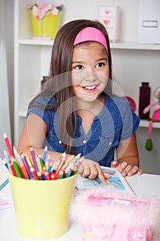 Portrait of a beautiful little girl reading a book