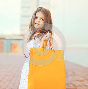 Portrait of beautiful little girl with shopping bag