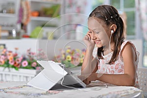 Portrait of beautiful little girl with tablet pc
