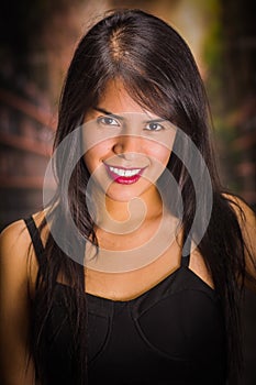 Portrait of a beautiful and lonely girl suffering of anorexy, looking at camera in a blurred background