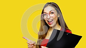Portrait of beautiful long hair female student wearing red t-shirt and nerd glasses, pointing with index finger at copy space,