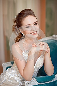 Portrait of Beautiful luxurious female model with medium brown hair in a long fashinable dress standing in the room.