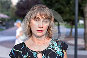Portrait of a beautiful mature woman of middle age 50 years old with blond hair with a pensive look