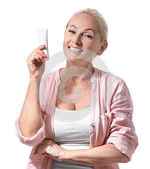 Portrait of beautiful mature woman with perfect skin holding tube of cream