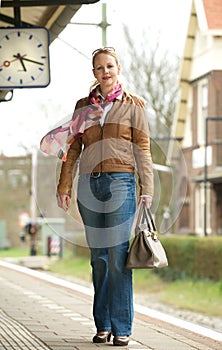 Portrait of a beautiful mature woman standing on train station platform