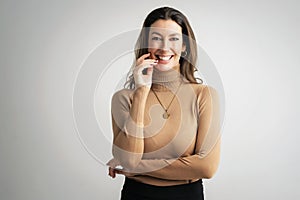 Portrait of beautiful mid aged woman with brunette hair wearing blazer and cheerful smiling against at isolated background