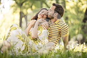 Portrait of beautiful middle age couple sitting at nature.