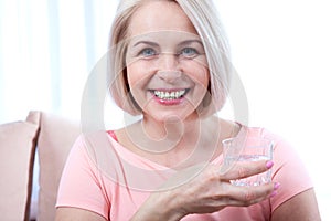 Portrait beautiful middle aged woman drinking water in the morning