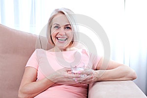 Portrait beautiful middle aged woman drinking water in the morning