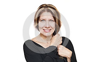 Portrait of a beautiful middle-aged woman on a white background. A woman smiles with a beautiful smile and holds her hand for her