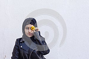 Portrait of beautiful middle-eastern girl in traditional Islamic clothing - hijab. Modern and young Iranian woman in leather