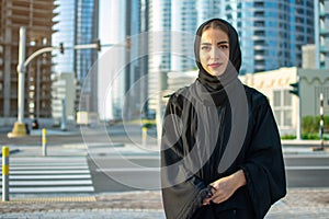 Portrait of beautiful middle eastern woman wearing abaya on the street.