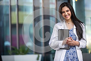 Portrait of a beautiful mixed ethnicity Hispanic Indian woman, medical professional, student, intern, or assistant at the workplac