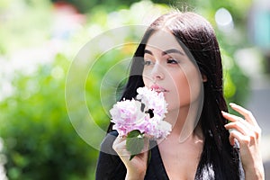 Portrait of beautiful model with make up outdoor. Beauty girl face. Woman with flowers.