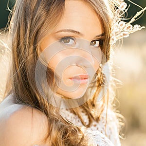 Portrait of a beautiful model in open field at sunrise - outdoors shot