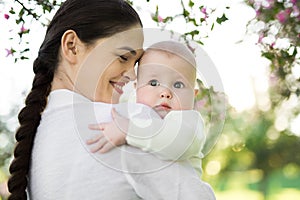 Portrait Beautiful Mother And Baby outdoors. Nature. Beauty Mum and her Child playing in Park.