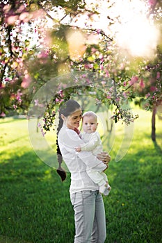 Portrait Beautiful Mother And Baby outdoors. Nature. Beauty Mum and her Child playing in Park.