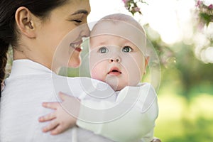 Portrait Beautiful Mother And Baby outdoors. Nature. Beauty Mum and her Child playing in Park.