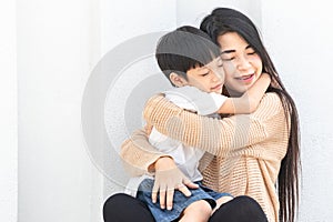 Portrait beautiful mother and child happily hugged. Asian family mom and child are hugging and closing their eyes, cute and warm