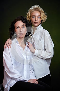 Portrait of beautiful mother daughter possing in a studio