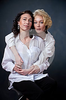 Portrait of beautiful mother daughter possing in a studio