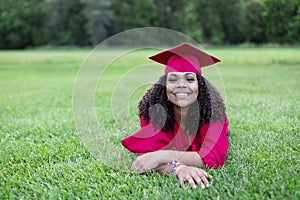 Portrait of a beautiful multiethnic woman in her graduation cap and gown