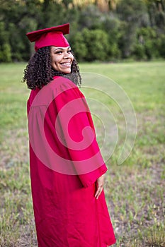 Portrait of a beautiful multiethnic woman in her graduation cap and gown