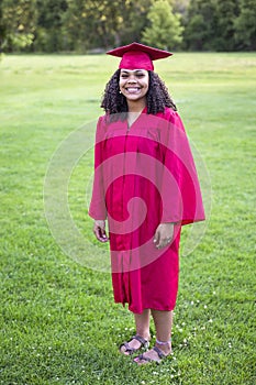 Portrait of a beautiful multiethnic woman in her graduation cap and gown