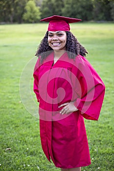 Portrait of a beautiful multiethnic woman in her graduation cap and gown photo
