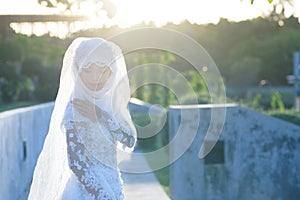 Portrait of a beautiful muslim bride with make up in white weddi