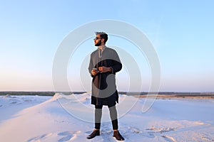 Portrait of beautiful Muslim guy in Kandura in middle of bottoml