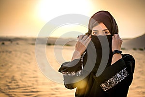 Portrait of beautiful Muslim woman wearing Hijab in the desert.